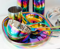 The ahimsa Rainbow Mindful Mealtime Set features shiny, iridescent plates, bowls, cups, and spoons in vibrant colors on white—an ideal fun and stylish dining set for children.