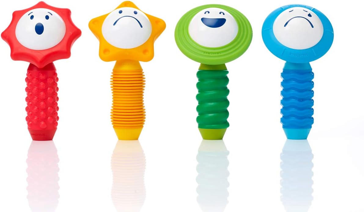 The Smartmax My First Sounds & Senses by Smart Toys includes four colorful rattles with different shaped handles that aid fine motor and sensory development; each rattle’s face shows surprise, sadness, concern, or happiness.