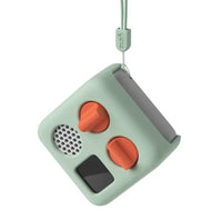 The Yoto Mini Adventure Jacket: Frog Soup by Yoto is a silicone protective case for the small, square, mint-green Yoto Mini—featuring two orange knobs, a speaker, black screen, and lanyard—for added style and protection.