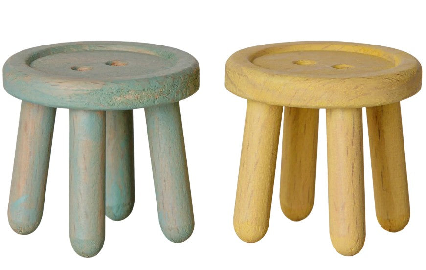 Set of two small, round wooden stools from Maileg—each with four sturdy legs, ideal as stools for Maileg mice. One is painted a charming mint and the other a soft light yellow. Both miniature stools feature button-like indents on top, making the Maileg Stool set, Mouse – Mint/Light yellow a delightful addition to your Maileg furniture collection.