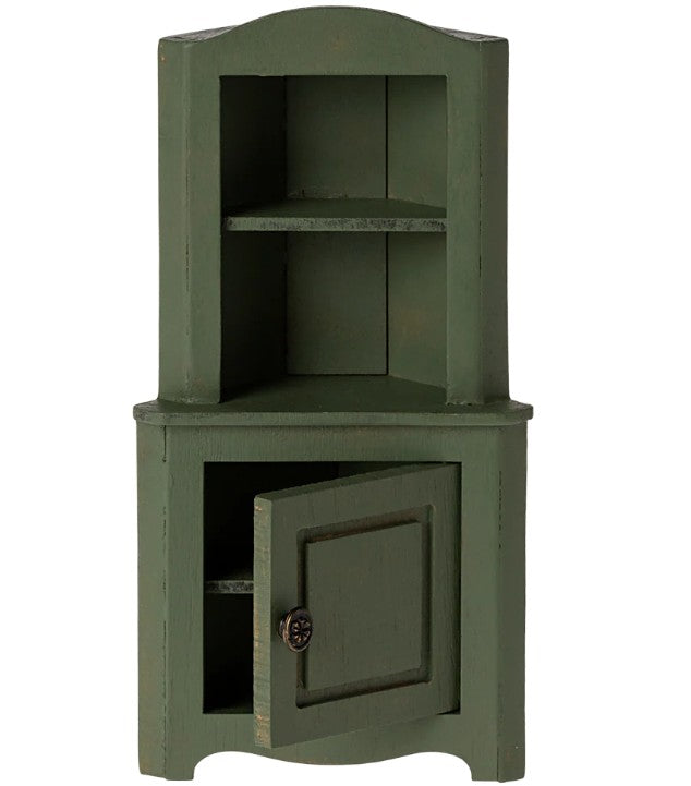 The Maileg Corner Cabinet, Mouse - Dark Green by Maileg is a small wooden cabinet for dollhouse storage, featuring an open top shelf and a lower door that reveals an inner shelf—perfect for organizing miniature mouse accessories.