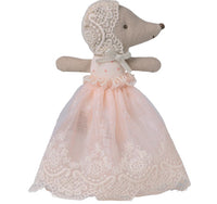 The Maileg Baby Mouse In Gown - Powder by Maileg features a tiny mouse in a pink dress and bonnet, standing with outstretched arms and detailed stitching—ideal for imaginative play.