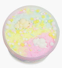 The Peachybbies Slime Pastel Cloud Cake Slime comes in a round container filled with yellow, pink, and blue pastel-colored fluffy slime that blend together for a dreamy effect. It is topped with star-shaped sprinkles and two small cloud-shaped decorations, offering a soft, cloud-like texture perfect for satisfying slime ASMR experiences.