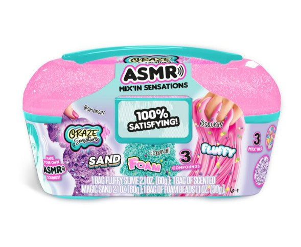 The Craze Sensations ASMR Mixin Sensations Caddy by License 2 Play features sand, foam, and fluffy slime sensory compounds in a vibrant pink and teal container. Perfect for sensory exploration, the label reads "100% Satisfying!" and displays images of the contents along with hands interacting with the different textures.