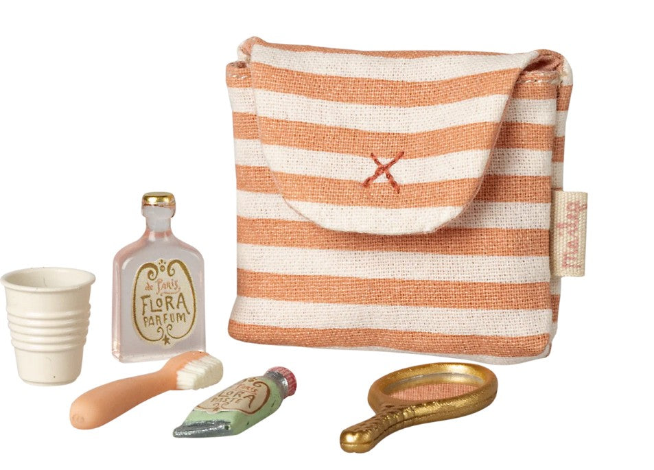 The Maileg Toothbrush Set In Bag, Mouse - Coral Stripe features a striped pouch and includes a toy cup, Flora Parfum bottle, brush, tube, and gold hand mirror—ideal Maileg accessories for pretend play.