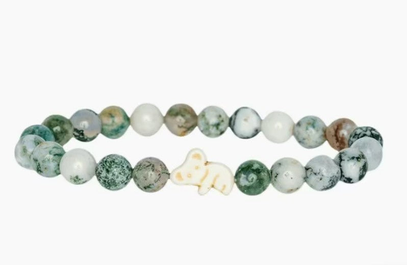 The fahlo Lounge - Eucalyptus Green Koala bracelet features round green and white marbled beads with a cream koala charm at the center—ideal for wildlife conservation fans. Shown on a white background.