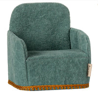 The Maileg Folding Chair, Mouse - Mint by Maileg is a small, plush mint armchair with a soft texture and gold trim, ideal for your Maileg Mouse accessories collection. Displayed against a white background.
