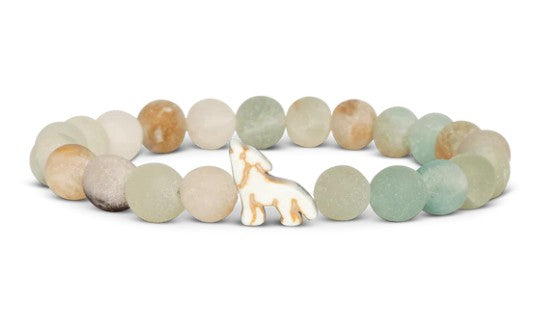 The Scout - Sky Stone Wolf bracelet by fahlo features round, matte stones in soft earthy tones and a central bead shaped like a howling wolf—ideal for wildlife conservation enthusiasts.