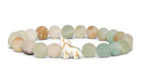 The Scout - Sky Stone Wolf bracelet by fahlo features round, matte stones in soft earthy tones and a central bead shaped like a howling wolf—ideal for wildlife conservation enthusiasts.