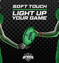 Two football players in green uniforms hold a glowing green Pro Glow Light-Up Football Size 6 from Thin Air Brands, LLC. Bold text reads: SOFT TOUCH LIGHT UP YOUR GAME. Black background with dotted pattern.