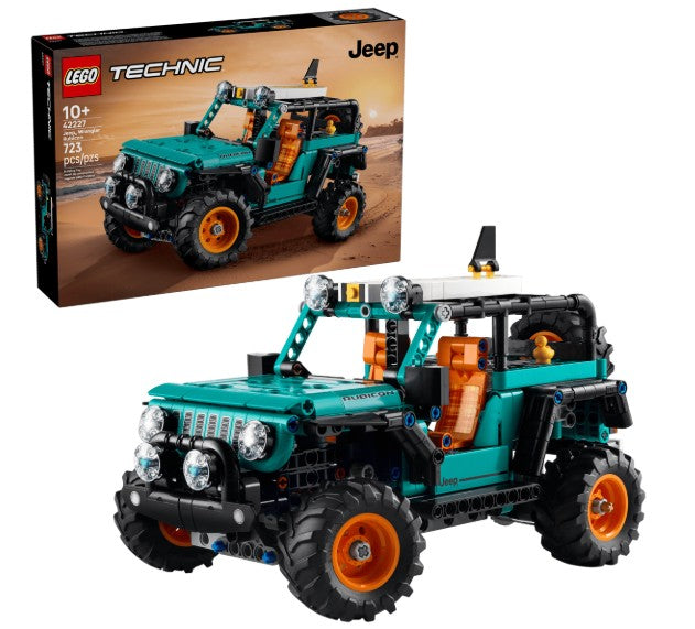 The LEGO Jeep Wrangler Rubicon SUV by LEGO features large tires and orange seats, displayed in front of its box that depicts the fully assembled off-road vehicle against a desert backdrop. Designed for ages 10 and up, this set includes 665 pieces.