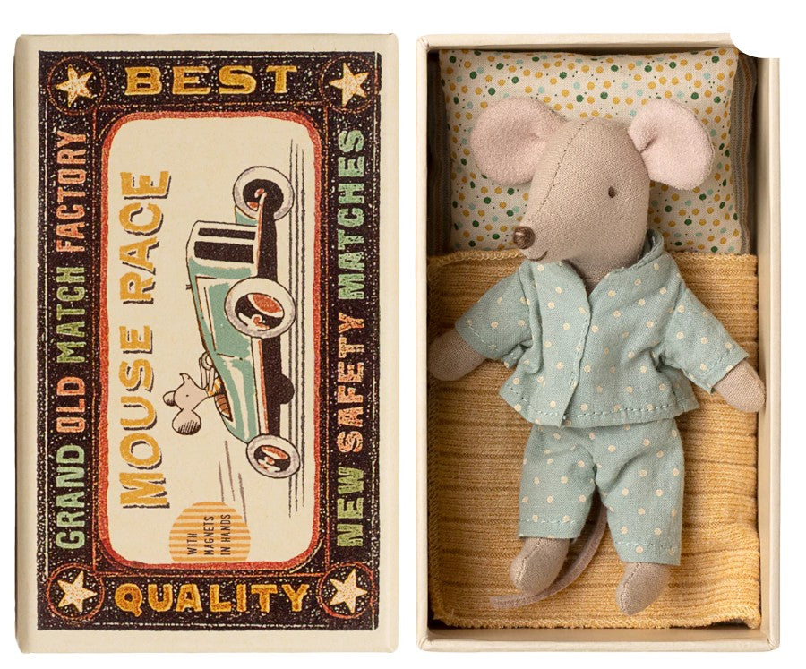 The Maileg Little Brother Mouse In Matchbox by Maileg comes dressed in blue polka-dot pajamas, lying in a matchbox bed with a yellow blanket. The box features vintage car-themed art and the words "Best Mouse Race.