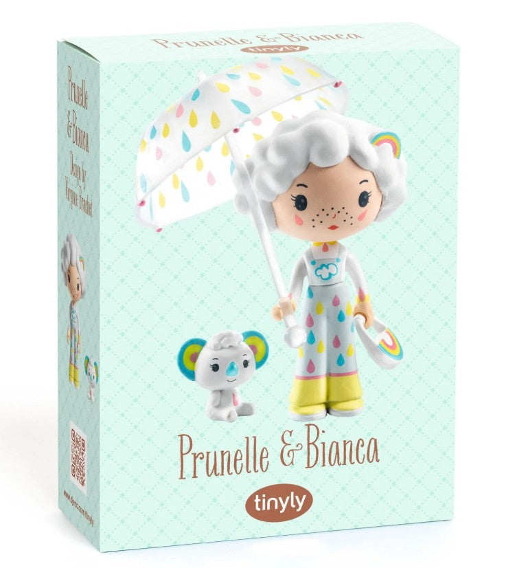 Discover the DJECO Tinyly Prunelle & Blanca toy box from DJECO, featuring collectible figurines of Prunelle—a girl with white hair in a raincoat holding an umbrella—and her small companion, Blanca. The light blue box showcases a charming diamond pattern, making it the perfect collectible set for fans of Tinyly miniature figures.