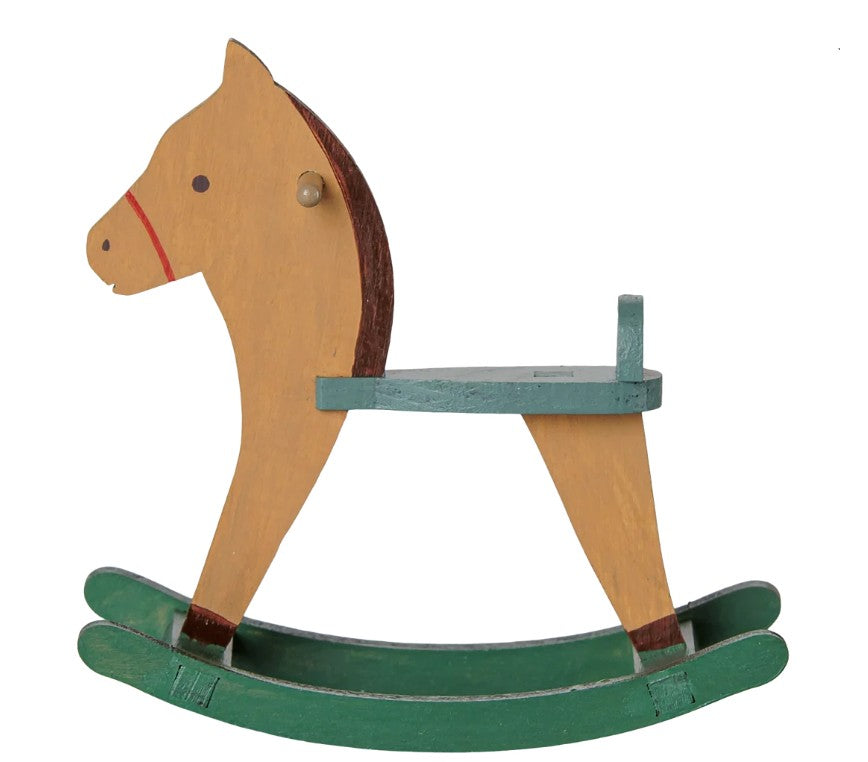 Maileg Rocking Horse, Mouse - Light Brown: An adorable wooden rocking horse toy from Maileg, featuring a light brown body, brown mane, and green seat with curved rockers. Shown in profile view against a white background—perfect as a charming accessory for Maileg mice or as a delightful addition to a nursery toy collection.