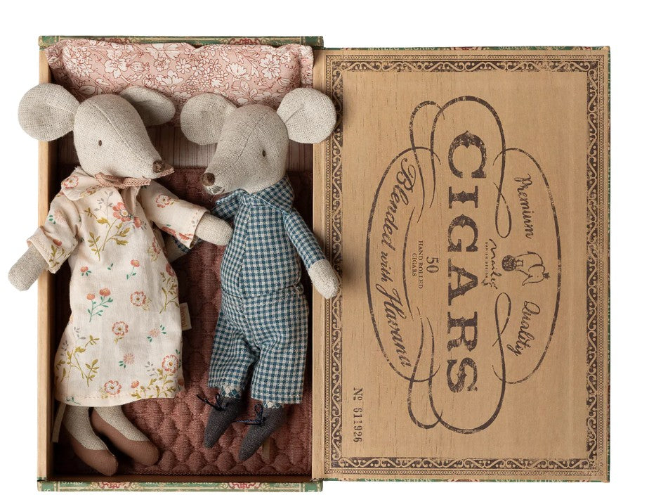 Maileg Grandma and Grandpa Mice in Cigarbox by Maileg feature two adorable mice dolls—Grandma in a floral dress and Grandpa in blue checkered overalls—nestled side by side in a vintage-style, fabric-lined cigar box.