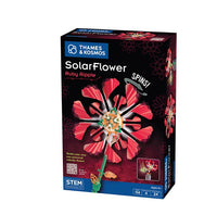 Box of the Thames & Kosmos SolarFlower - Ruby Ripple STEM kit featuring a vibrant red, solar-powered flower model with spinning petals. Text highlights: SPINS! and Build your own sun-powered robotic flower. This educational toy introduces kids ages 8+ to renewable energy concepts.