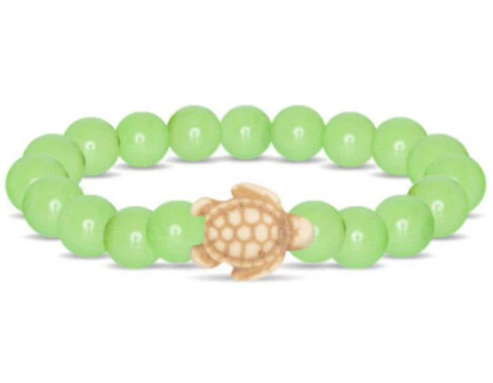 The Journey - Sage Glow Sea Turtle bracelet by fahlo features light green round beads and a small tan turtle charm at the center.