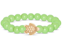 The Journey - Sage Glow Sea Turtle bracelet by fahlo features light green round beads and a small tan turtle charm at the center.