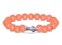 The Voyage - Sunrise Glow Shark bracelet by fahlo features round, coral-colored beads and a gray shark charm—ideal for marine conservation fans or anyone seeking a unique shark tracking accessory.