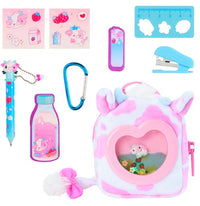 A pink and white Toysmith Moose Toys Real Littles Liquid Charms Backpack with a heart-shaped window, featuring cute animal and strawberry designs, includes a blue pen with cow charm, stickers, mini ruler, bookmark, stapler, blue carabiner, and a strawberry milk-shaped notepad—plus surprise miniature accessories inside.