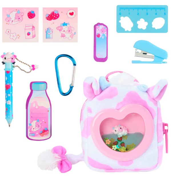A pink and white Toysmith Moose Toys Real Littles Liquid Charms Backpack with a heart-shaped window, featuring cute animal and strawberry designs, includes a blue pen with cow charm, stickers, mini ruler, bookmark, stapler, blue carabiner, and a strawberry milk-shaped notepad—plus surprise miniature accessories inside.