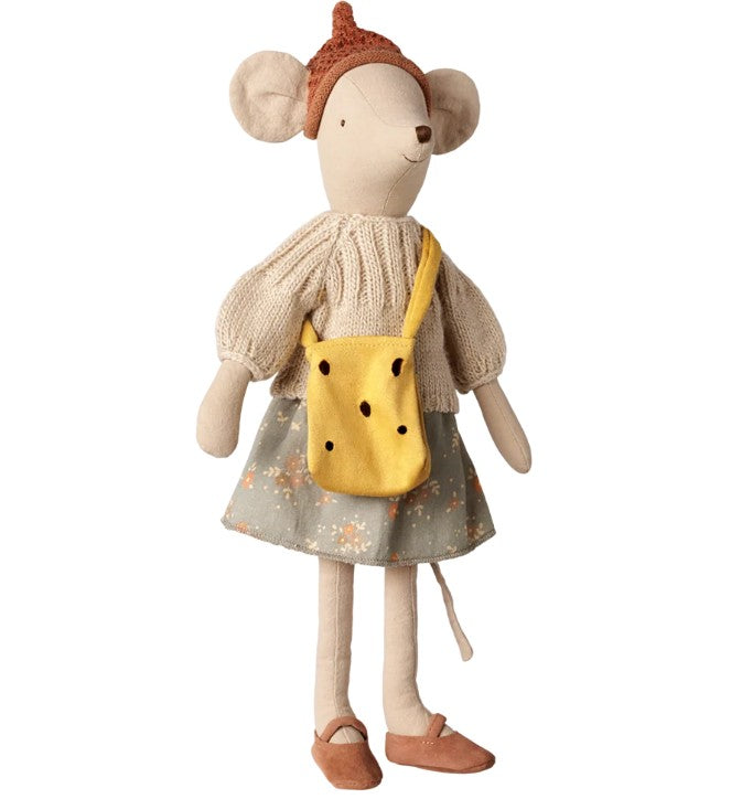 The Maileg Cheese Bag, Medium Mouse by Maileg is a medium-sized stuffed mouse toy dressed in a knit sweater, pointy brown hat, patterned skirt, brown shoes, and carries a yellow cheese bag with dark spots. Perfect for imaginative play, this charming mouse stands upright and faces slightly to the right.