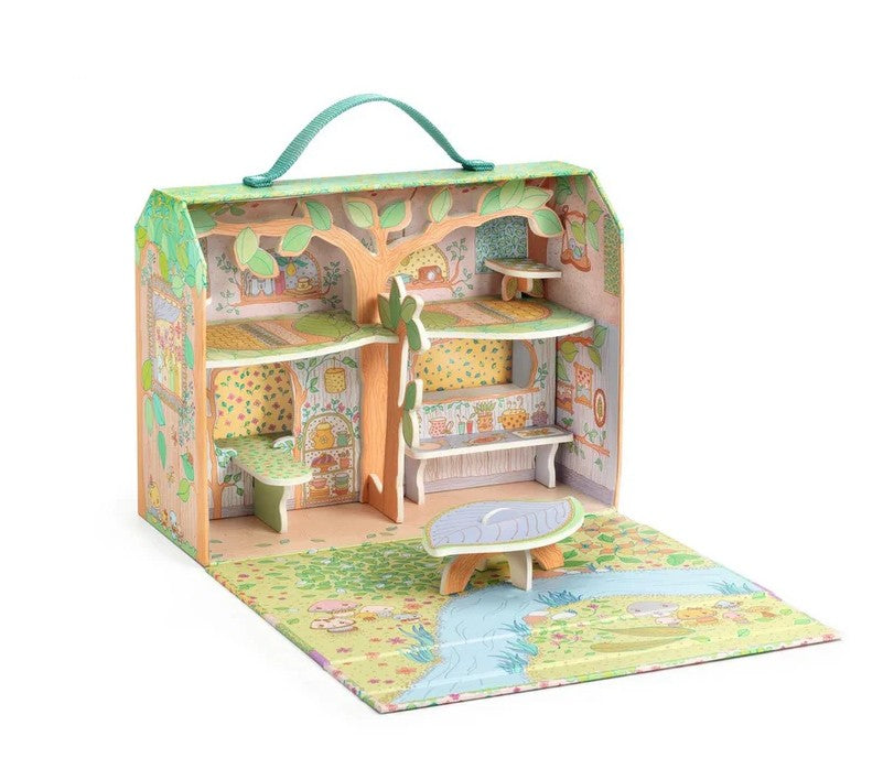 The DJECO Sylvia & Fox House is a colorful wooden Tinyly house designed like a suitcase, which opens to reveal multiple rooms, staircases, a bench, and a play mat featuring a stream and garden theme. Perfect for imaginative play, this miniature DJECO playset also includes a green carrying handle on top for easy transport.