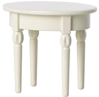 The Maileg Side Table, Mouse by Maileg is a small white wooden oval table with four turned legs, ideal for dollhouses or Maileg Mouse furniture, pictured on a plain white background.