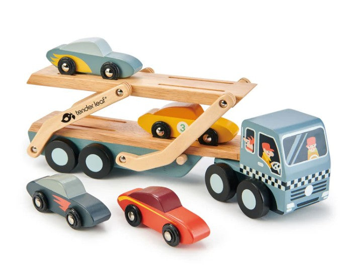 The Tenderleaf Car Transporter is a wooden play set featuring a checkered cab, four colorful cars, movable ramps, and playful driver illustrations for imaginative play. Two cars sit on the transporter, with two more beside it.