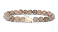 Beaded bracelet featuring round, mottled brown stones and a white giraffe-shaped centerpiece bead, inspired by the adventurous spirit of the fahlo Scout - Moon Wolf tracking bracelet.