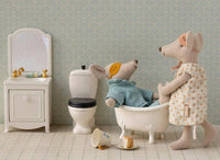 Maileg Mum & Dad Mice In Cigarbox by Maileg features Mum in a polka-dot dress and Dad relaxing in the tub, with a vanity, toilet, and spilled tea—charming details for their miniature bathroom and tiny home.