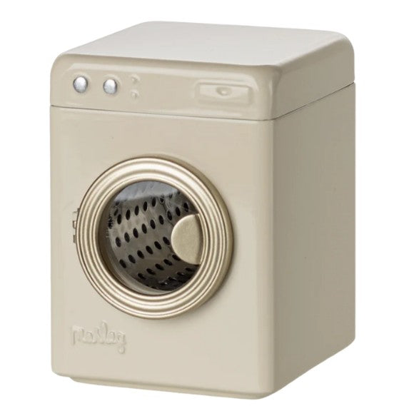 The Maileg Washing Machine, Mouse – Off white is a rectangular miniature washing machine by Maileg, featuring a beige color with a round, clear metallic-finished door and two buttons on top. The visible perforated drum and simple molded details make it perfect for Maileg mouse accessories or as a charming addition to your collection.