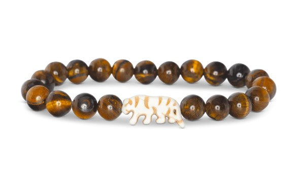 Introducing the fahlo Prowl - Tiger's Eye bracelet, featuring round brown Tiger's Eye beads and a central white elephant-shaped bead, thoughtfully crafted to support wildlife conservation.