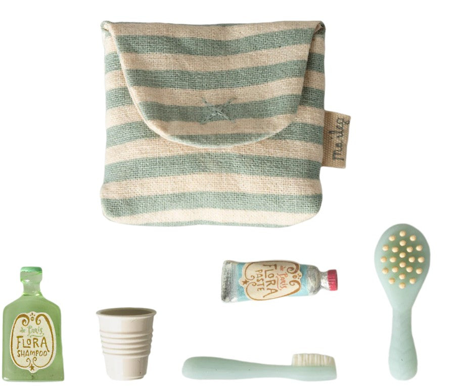 The Maileg Toothbrush Set In Bag, Mouse - Blue Stripe by Maileg features a striped pouch with five mini items—a Flora Shampoo bottle, beige cup, toothpaste tube, green hairbrush, and light green toothbrush—ideal for dollhouse or mouse sets.