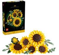 A LEGO Sunflower Bouquet from LEGO’s Botanical Collection, featuring buildable flowers with vibrant yellow petals and brown centers, is displayed in front of its product box, which showcases the completed bouquet against a sleek black background.