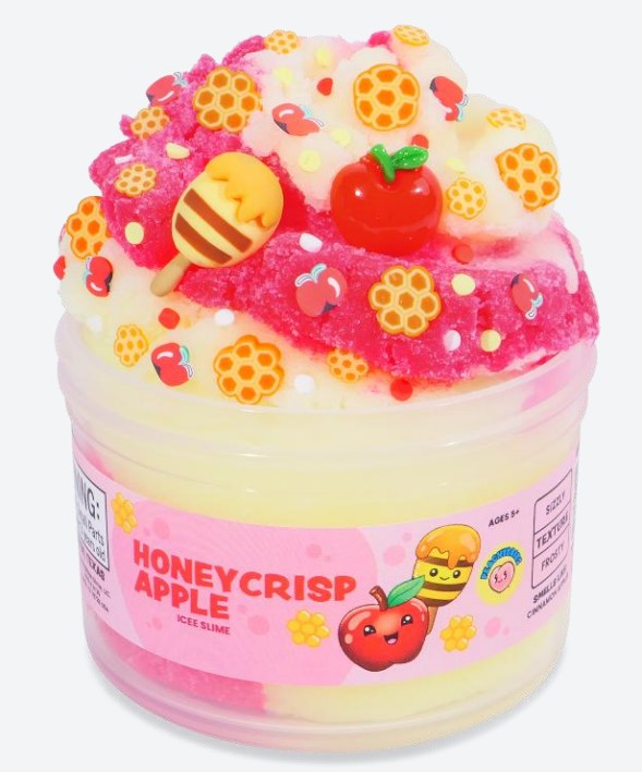 A jar of Peachybbies Slime's Honey Crisp Apple Slime offers a delightful sensory experience with its pink and yellow swirls, topped with faux apple, honeycomb, and honey details. The label features cartoon apples and honeycombs, capturing the autumn-inspired charm of this Honey Crisp Apple Slime.