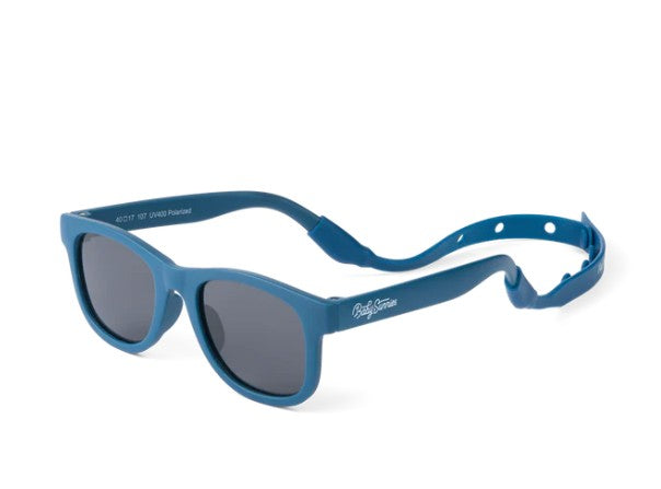 Baby Sunnies Navy Blue Baby Polarized Sunglasses feature dark lenses and a flexible, adjustable strap for a secure fit and excellent UV protection for your little one. The text "Polaroid" is displayed on the left arm near the hinge. These baby sunglasses are shown against a white background.