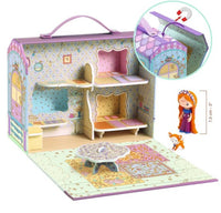 The DJECO Tinyly Bluchka & Indie House is a vibrant, fold-out playset by DJECO featuring two floors, furniture, and a table. This charming miniature house includes a Bluchka doll and Indie animal figure from the Tinyly figurines collection (shown beside a size reference). An inset image highlights the convenient carrying handle on this delightful set.