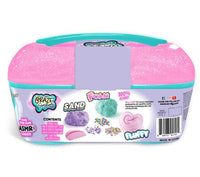 The Craze Sensations ASMR Mixin Sensations Caddy by License 2 Play is a teal and pink plastic container featuring sand, foam, and fluffy slime—ideal for making ASMR sounds and sensory exploration. The packaging displays small images of colorful sand, foam, beads, and pink slime, offering perfect sensory compounds for creative ASMR play.
