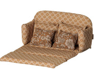 A large, ocher Maileg Sofa bed for mice, featuring two matching pillows and shown unfolded to display its bed function, is set against a white background.