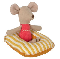 A small Maileg mouse toy dressed in a red swimsuit sits on the Maileg Rubber boat, Small mouse - Yellow stripe, ideal for imaginative play or pairing with other miniature accessories.