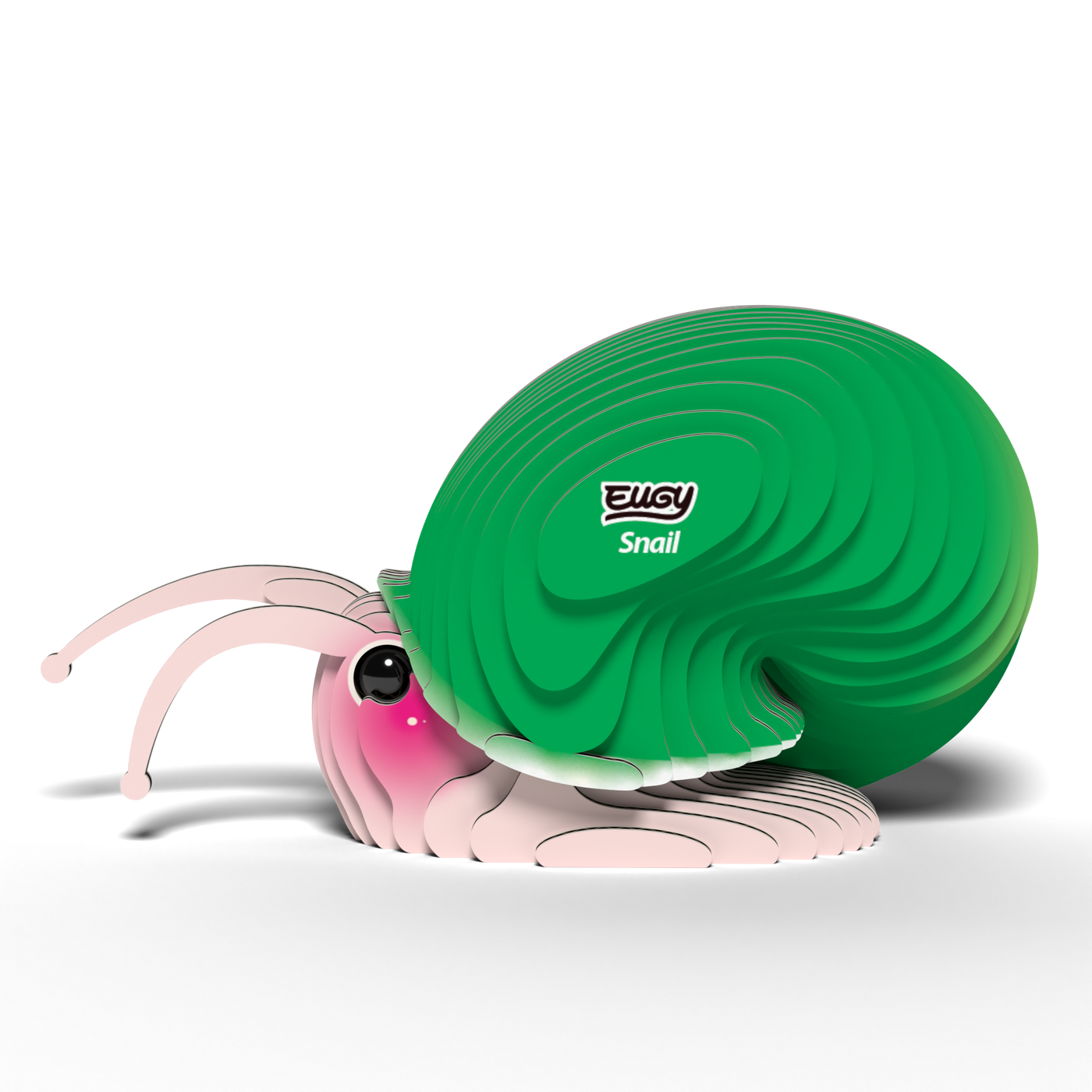 A cute, cartoon-style snail with a big green shell and pink face sits on white. Its shell is labeled EUGY Snail—a fun 3D puzzle and eco-friendly toy from Eugy, featuring expressive eyes and antennae.
