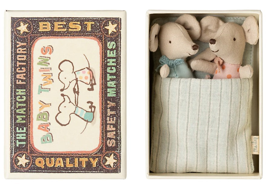 Maileg Twins, Baby Mice in Matchbox by Maileg features two adorable baby mice nestled side by side in a striped matchbox bed—a delightful gift for any occasion.