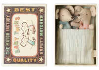 Maileg Twins, Baby Mice in Matchbox by Maileg features two adorable baby mice nestled side by side in a striped matchbox bed—a delightful gift for any occasion.
