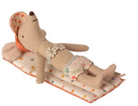 A Maileg mouse relaxes on the Maileg Air Mattress, Mouse - Multi dot, wearing a floral swimsuit and orange sunhat—an adorable setup by Maileg that’s perfect for imaginative pretend play.