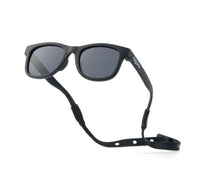 Baby Sunnies Black Baby Polarized Sunglasses Strap UV Protection 0-24M feature dark, polarized UV-protective lenses and an adjustable black strap, shown on a white background.