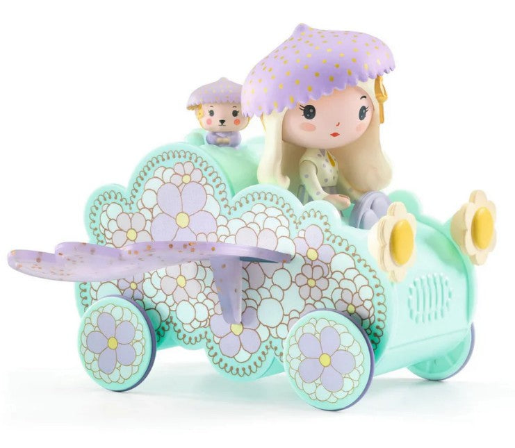 The DJECO Tinyly Jil Tinycar by DJECO is a pastel-colored miniature vehicle decorated with floral patterns, featuring a Tinyly Jil figurine wearing a purple polka-dot hat and a small matching companion in the back seat—perfect for inspiring imaginative play.