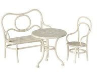 The Maileg Café Set, Mouse, Small – Off White by Maileg includes a curved bench, round perforated table, and matching chair with vintage looping designs—ideal for miniature tableware or Maileg Mouse displays.