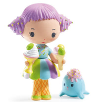 Meet DJECO Tinyly Tutti & Frutti, a delightful collectible figure from DJECO featuring Tutti with vibrant purple hair. She’s dressed in a playful rainbow dress and orange grid-patterned tights, holding an ice cream cone and a sundae. Beside her sits Frutti, an adorable blue seal topped with a sprinkle-covered scoop—perfect for imaginative play or collecting!.