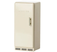 The Maileg Fridge, Mouse - Off White by Maileg is a small, single-door refrigerator with "Maileg" on the front, a vertical handle, and black vents—ideal for any Maileg Mouse collection or as an adorable miniature fridge.